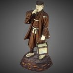 Japanese Meji period statue of a man smoking